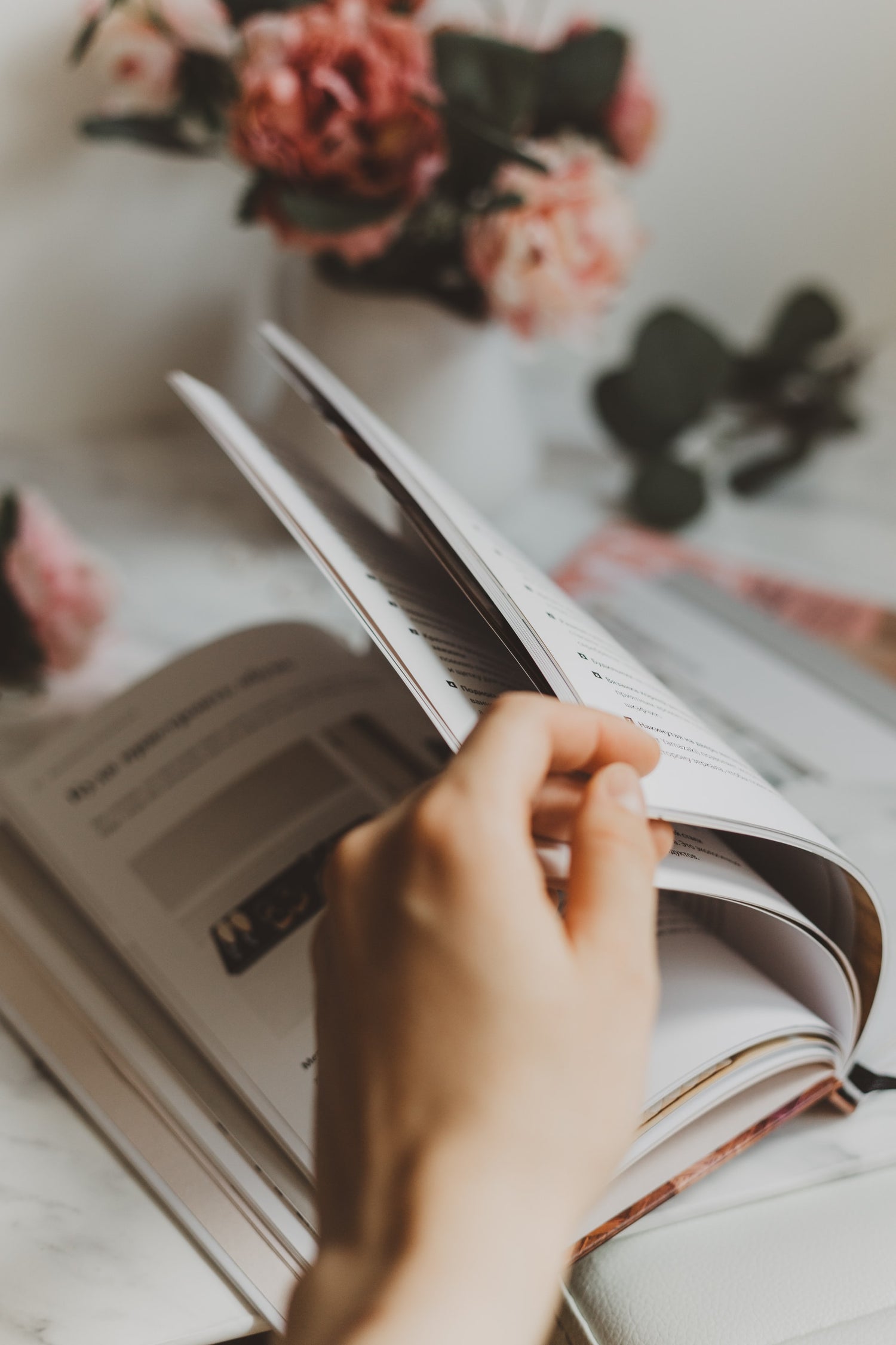 hand flipping through pages of a book