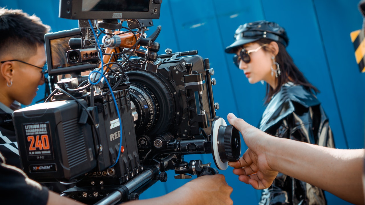 lady in black leather being filmed