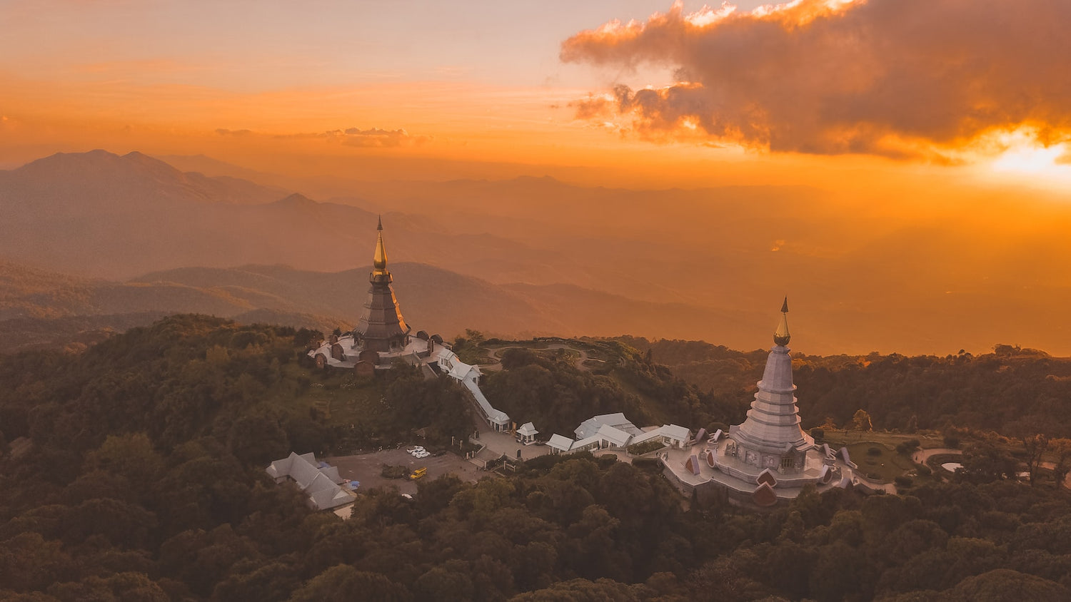 Thailand temples on mountain with golden sunset